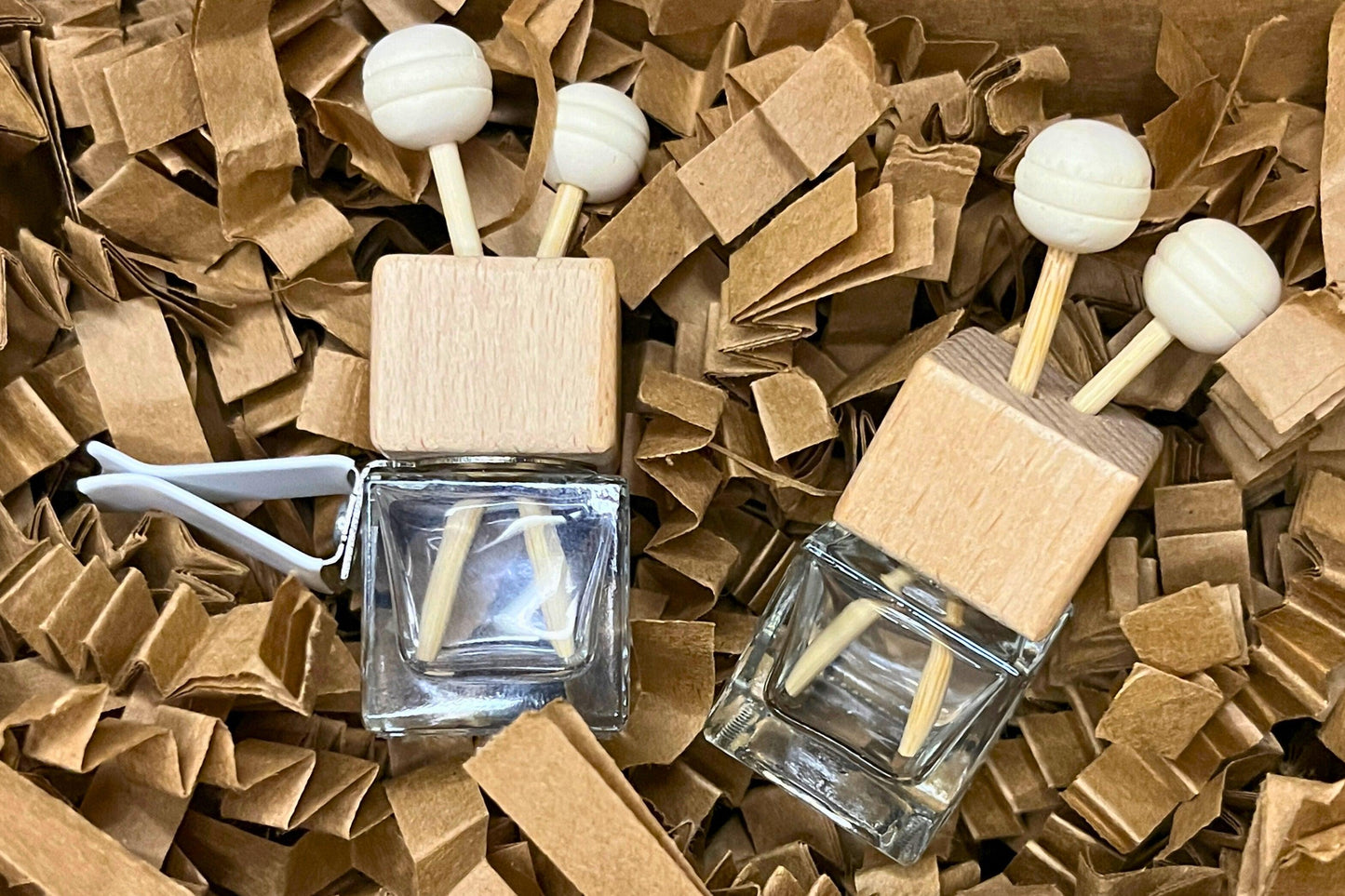 Customizable car vent diffuser with a natural wooden cap and sleek glass bottle. Handcrafted, offering long-lasting, personalized fragrances for cars, small spaces, or on-the-go aromatherapy. Elevate your drive with a touch of elegance and freshness.