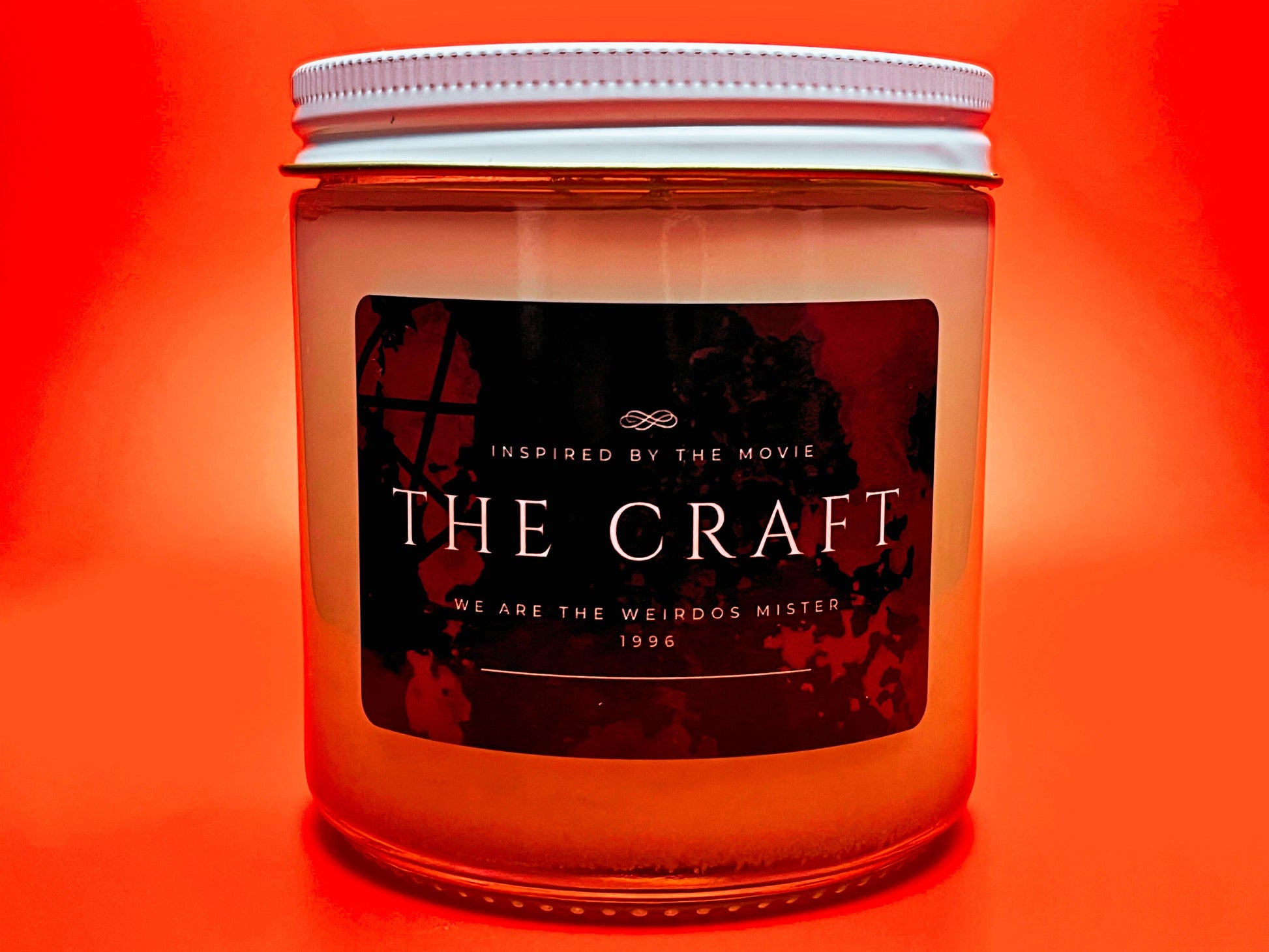 Hand-poured soy candle inspired by the cult classic movie The Craft. Bold black and red label, perfect for fans of 90s nostalgia and gothic vibes. Infused with spellbinding scents, it is ideal for creating a mysterious and enchanting atmosphere