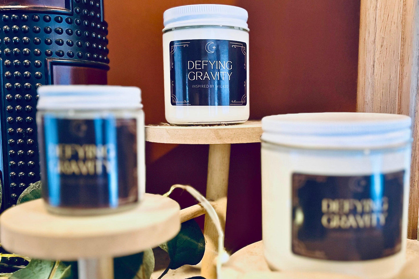 Hand-poured soy candle inspired by Wicked’s; Defying Gravity. Featuring bold, magical scents and a celestial moon and star label, it’s perfect for theater fans and those seeking an enchanting fragrance experience to elevate their space.
