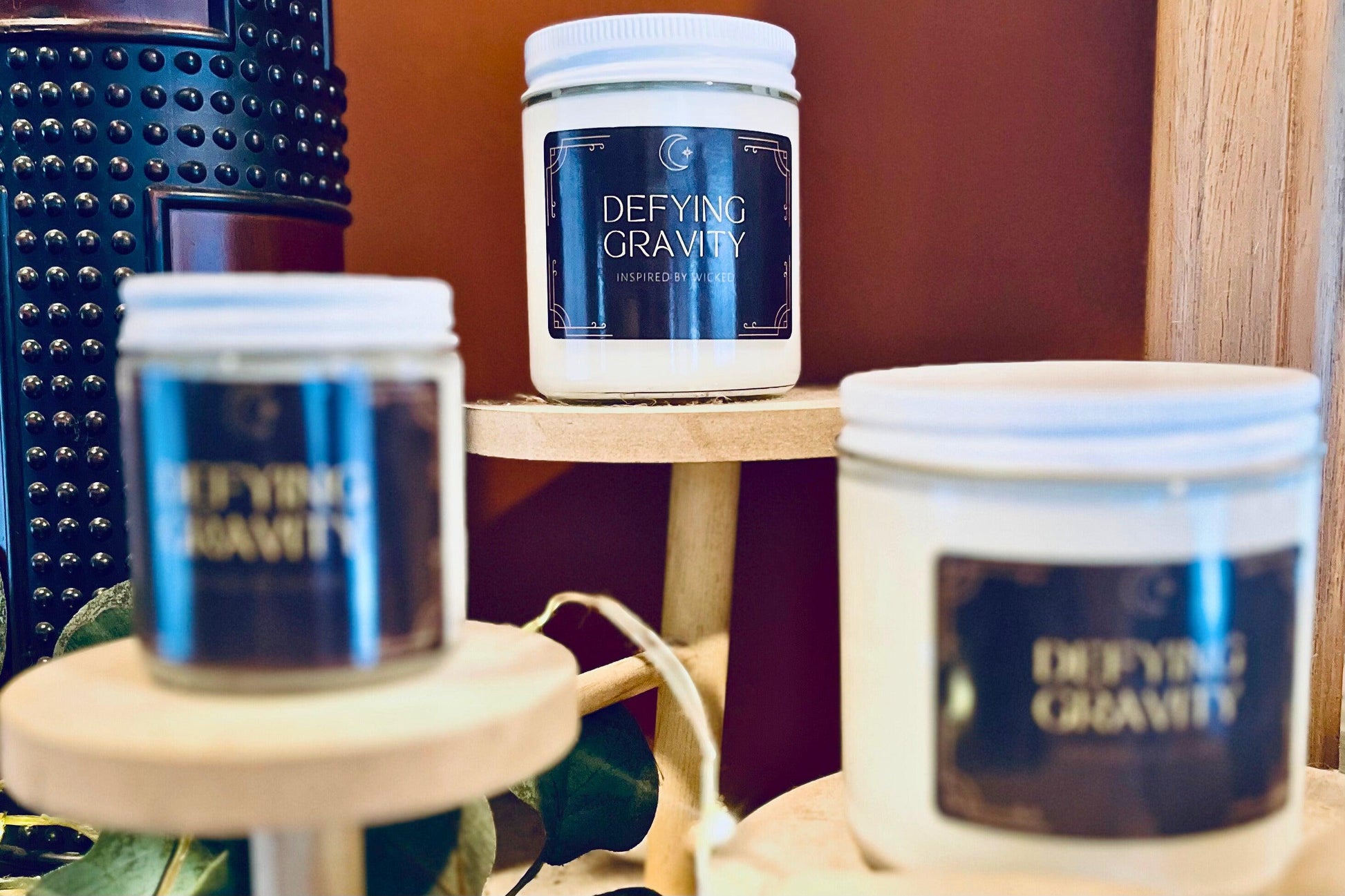 Hand-poured soy candle inspired by Wicked’s; Defying Gravity. Featuring bold, magical scents and a celestial moon and star label, it’s perfect for theater fans and those seeking an enchanting fragrance experience to elevate their space.