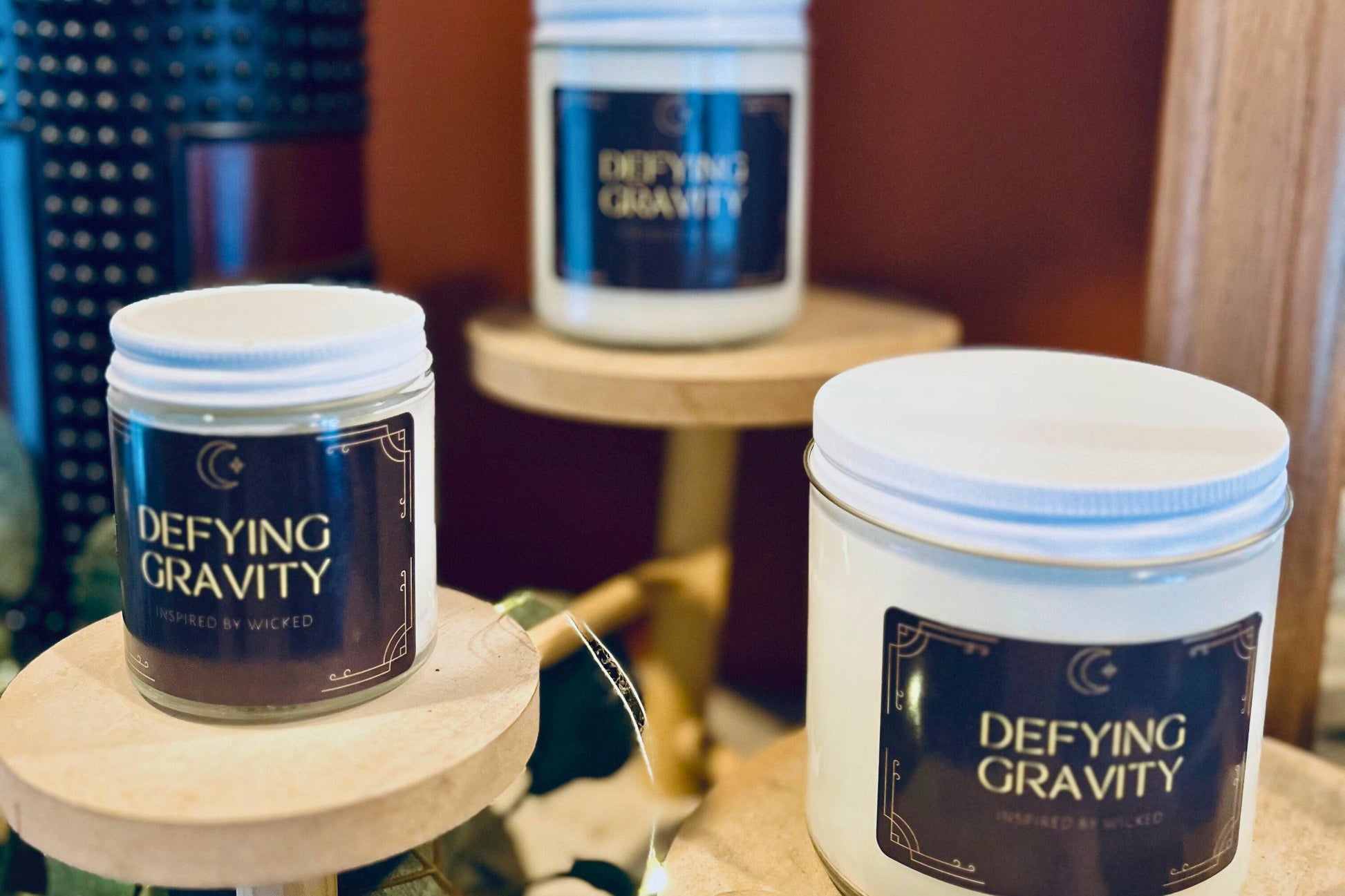 Hand-poured soy candle inspired by Wicked’s; Defying Gravity. Featuring bold, magical scents and a celestial moon and star label, it’s perfect for theater fans and those seeking an enchanting fragrance experience to elevate their space.
