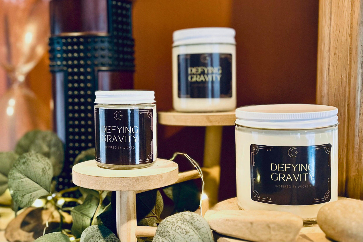 Hand-poured soy candle inspired by Wicked’s; Defying Gravity. Featuring bold, magical scents and a celestial moon and star label, it’s perfect for theater fans and those seeking an enchanting fragrance experience to elevate their space.