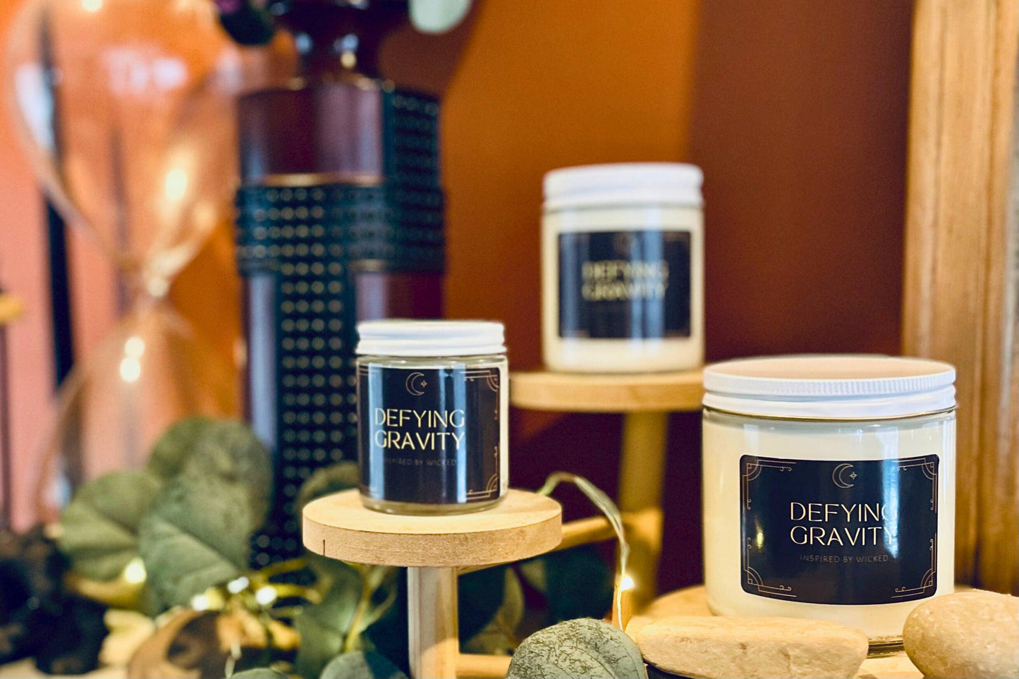 Hand-poured soy candle inspired by Wicked’s; Defying Gravity. Featuring bold, magical scents and a celestial moon and star label, it’s perfect for theater fans and those seeking an enchanting fragrance experience to elevate their space.