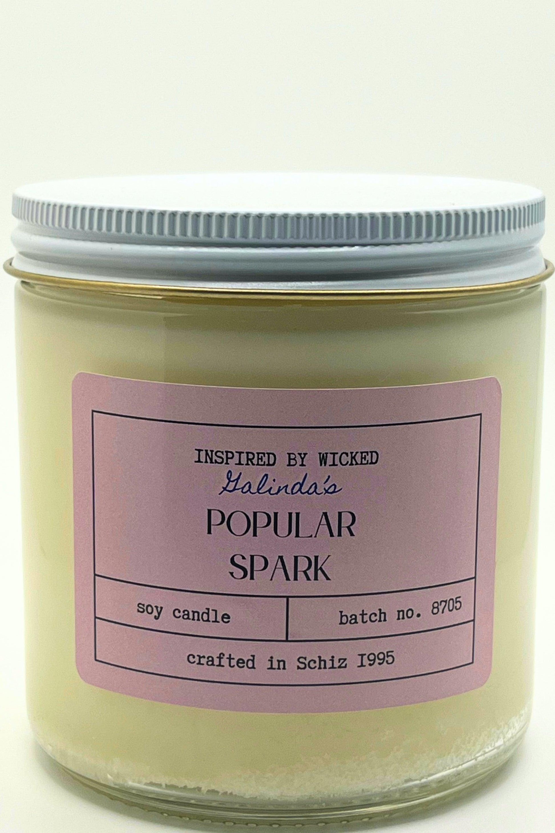 Handcrafted soy candle inspired by Wicked's Galinda, featuring a Popular Spark pink label. Infused with enchanting fragrances, it adds a touch of magic and whimsy to your space. Perfect for unique gifting or personal enjoyment.