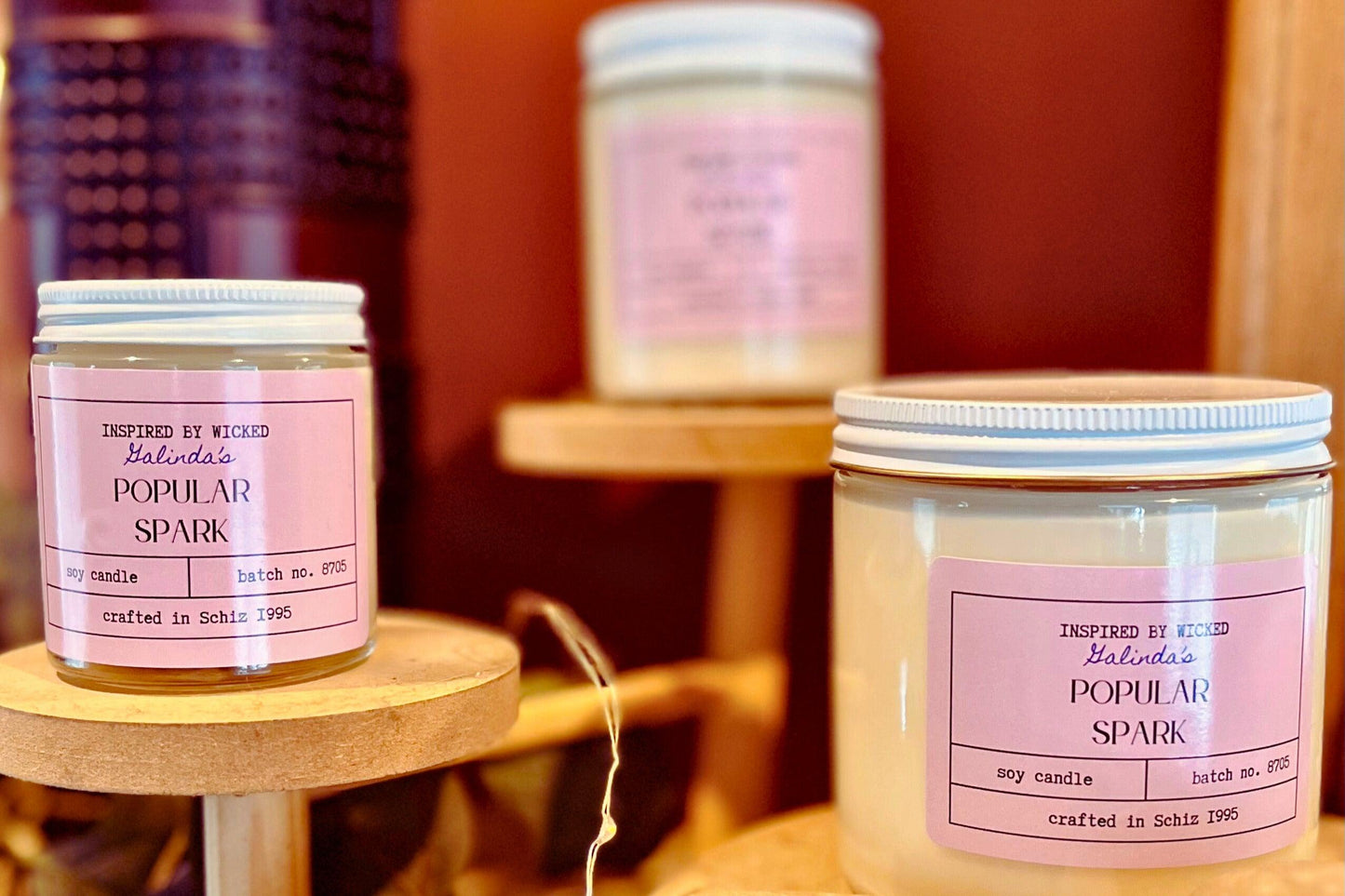 Handcrafted soy candle inspired by Wicked's Galinda, featuring a Popular Spark pink label. Infused with enchanting fragrances, it adds a touch of magic and whimsy to your space. Perfect for unique gifting or personal enjoyment.