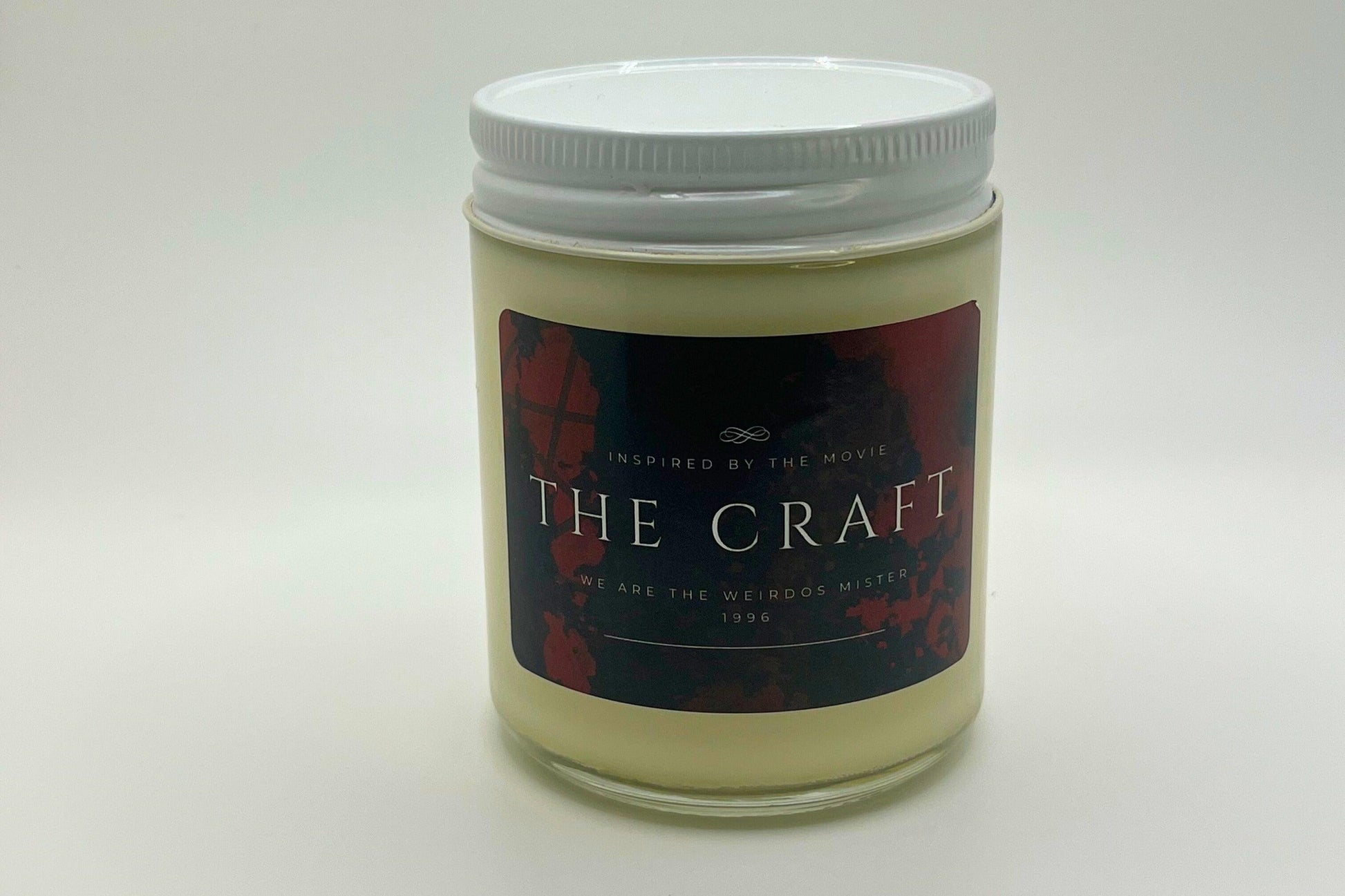 Hand-poured soy candle inspired by the cult classic movie The Craft. Bold black and red label, perfect for fans of 90s nostalgia and gothic vibes. Infused with spellbinding scents, it is ideal for creating a mysterious and enchanting atmosphere